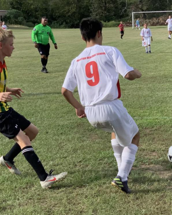 chs soccer player with number 9 on jersey running toward soccer ball