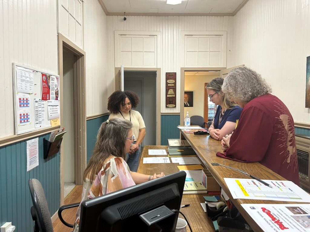 administrative team praying together in front of office at CHS